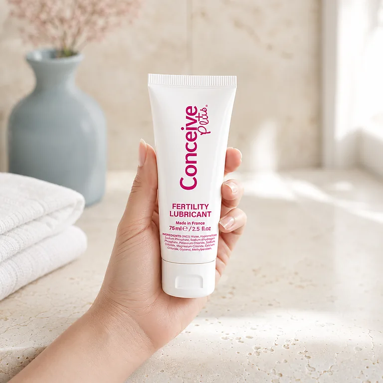 Hand holding the Conceive Plus 75 mL fertility lubricant tube