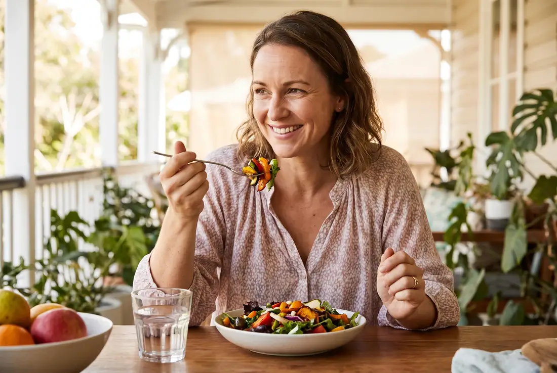 Woman enjoying a meal on a sunny verandah